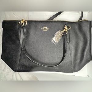 Black Coach shoulder bag with gold colored hardware. NWT